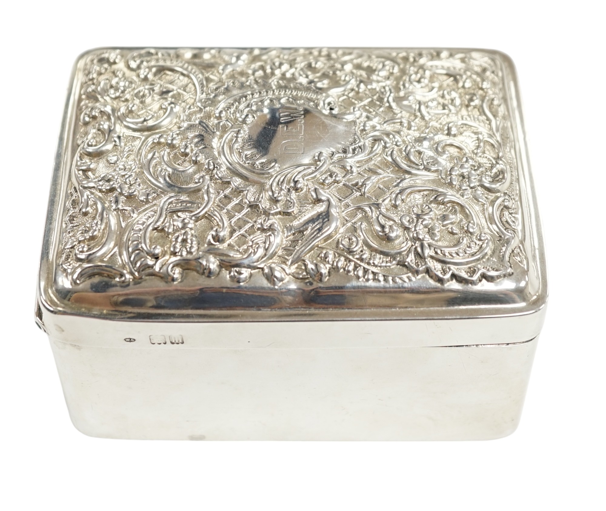 An Edwardian silver trinket box, with repousse hinged cover, William Comyns, London, 1907, 11cm. Condition - poor to fair